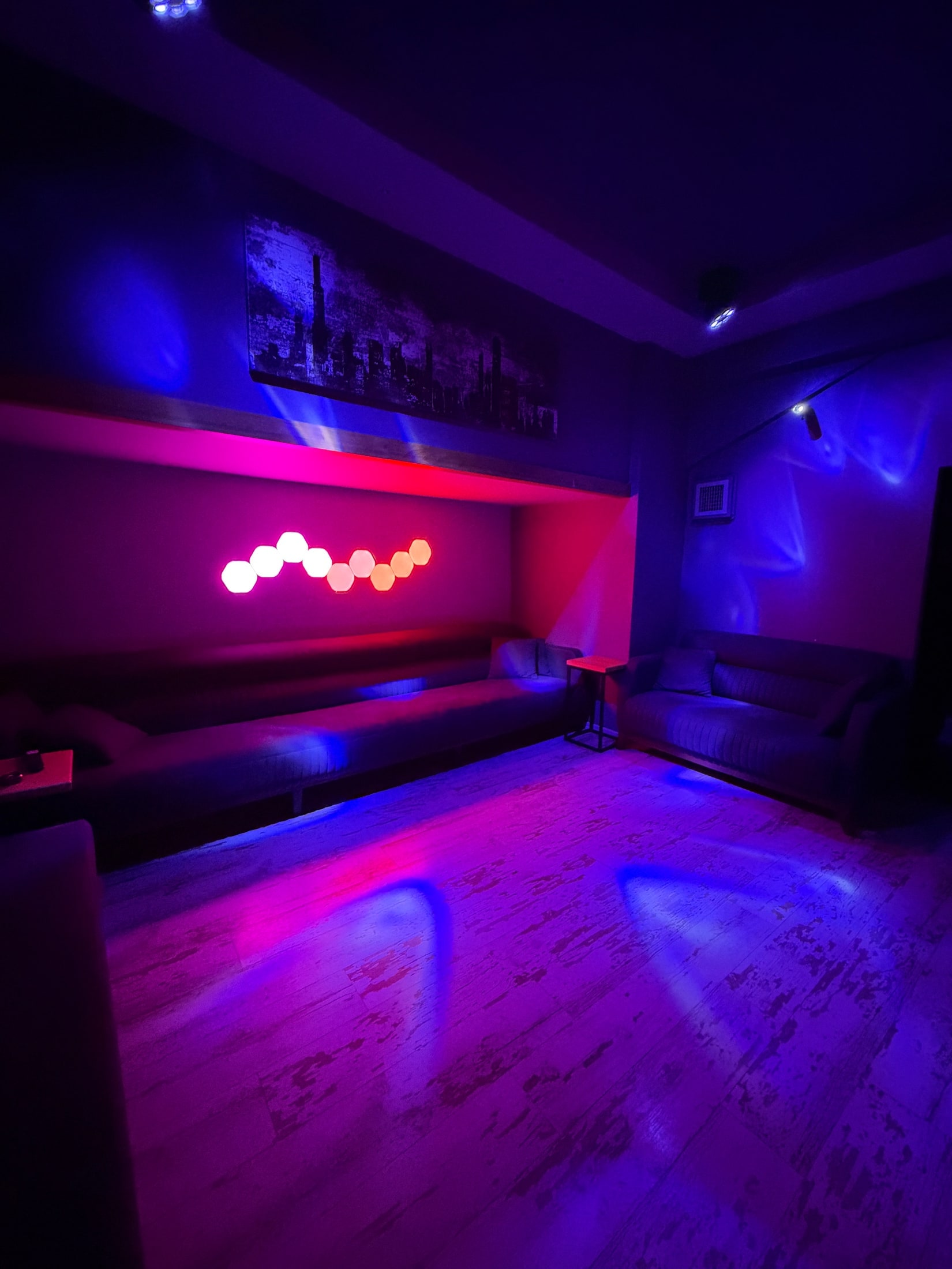 Mor ve pembe ışıklarla aydınlanan lounge salonu